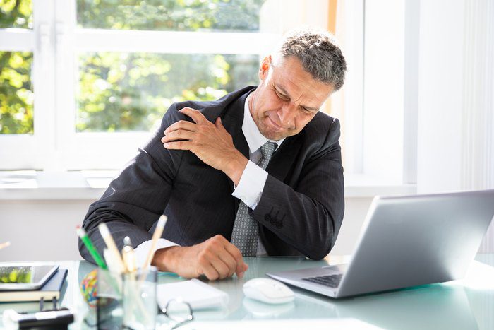 man working with hurting shoulder