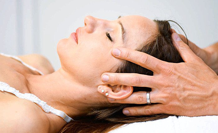 woman receives head massage
